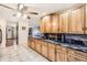 Bright kitchen with tile flooring, granite counters, oak cabinets and stainless appliances at 11123 Clermont Dr, Thornton, CO 80233