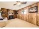 Carpeted living room with a fireplace, built-in shelving, and a window for natural light at 11123 Clermont Dr, Thornton, CO 80233