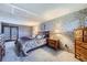 Spacious primary bedroom featuring carpet, a dresser, and a sliding glass door at 11123 Clermont Dr, Thornton, CO 80233
