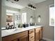 Double vanity bathroom with modern fixtures and large mirror at 2515 W 69Th Pl, Denver, CO 80221