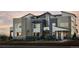 Modern three-story home with stone accents and landscaped yard at 2515 W 69Th Pl, Denver, CO 80221