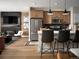 Modern kitchen with wood cabinets, a large island with seating, and stainless steel appliances at 2515 W 69Th Pl, Denver, CO 80221