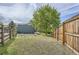 View of grassy backyard with wooden fence and mature tree providing shade at 9430 Carr St, Westminster, CO 80021