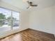 The bedroom has wood laminate flooring, a ceiling fan, and a large window at 9430 Carr St, Westminster, CO 80021