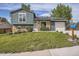 Charming two-story home featuring a well-manicured lawn, brick accents, and solar panels on the roof at 9430 Carr St, Westminster, CO 80021