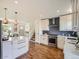 Well-lit kitchen with white cabinetry, stainless steel appliances, subway tile backsplash, and island at 9430 Carr St, Westminster, CO 80021