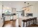 Bright kitchen featuring white cabinetry, stainless steel appliances, and a stylish island with seating at 9430 Carr St, Westminster, CO 80021