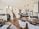 Inviting open-concept living space with modern kitchen, dining area, staircase, and stylish decor at 9430 Carr St, Westminster, CO 80021