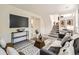 Modern living room featuring comfortable seating, an entertainment area, and a staircase at 9430 Carr St, Westminster, CO 80021