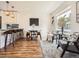 Open concept living space with barstool seating and dining space adjacent to the modern kitchen at 9430 Carr St, Westminster, CO 80021