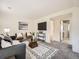 Comfortable living room with soft carpet, modern decor, and television on wall at 9430 Carr St, Westminster, CO 80021