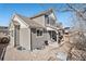 Exterior view of the backyard featuring a patio, gravel landscaping, and a fenced yard at 1698 Odyssey Ct, Castle Rock, CO 80109