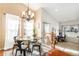 Cozy dining area features ample natural light, modern chandelier, and flows into office at 1698 Odyssey Ct, Castle Rock, CO 80109