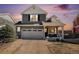 Charming two-story home featuring well-maintained landscaping, attached garage, and inviting front porch at 1698 Odyssey Ct, Castle Rock, CO 80109