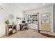 Bright home office with large window, desk setup, and shelving for organized workspace at 1698 Odyssey Ct, Castle Rock, CO 80109