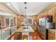 Bright kitchen with stainless appliances, wood cabinets, granite countertops, and central island with bar stool seating at 1698 Odyssey Ct, Castle Rock, CO 80109