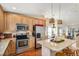 Modern kitchen features stainless steel appliances, hardwood floors, and ample cabinet space at 1698 Odyssey Ct, Castle Rock, CO 80109