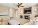 View of living room showcasing a cozy fireplace, TV, neutral paint and decor, and entry to the house at 1698 Odyssey Ct, Castle Rock, CO 80109