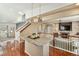 Open concept living room and kitchen with granite island, and seamless transition to the kitchen at 1698 Odyssey Ct, Castle Rock, CO 80109
