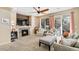 Cozy living room with a stone fireplace, comfortable seating, and sliding glass doors to the outdoor patio at 1698 Odyssey Ct, Castle Rock, CO 80109