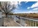 Enjoy the view from this home's spacious wooden deck with white railing at 5204 Shetland Ct, Highlands Ranch, CO 80130