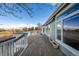 Spacious wooden back deck with white railing and stairs offers scenic views at 5204 Shetland Ct, Highlands Ranch, CO 80130