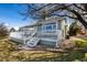 Rear exterior showcasing a spacious deck with white railings and stairs at 5204 Shetland Ct, Highlands Ranch, CO 80130