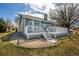 Well-maintained backyard with deck, grass, and a stone foundation at 5204 Shetland Ct, Highlands Ranch, CO 80130