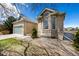 Charming brick home featuring an attached two-car garage and landscaped front yard at 5204 Shetland Ct, Highlands Ranch, CO 80130