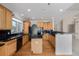 Traditional kitchen with wood cabinets, black countertops, and hardwood floors at 5204 Shetland Ct, Highlands Ranch, CO 80130