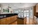 This bright kitchen with black countertops, oak cabinets and hardwood floors leads to the living room at 5204 Shetland Ct, Highlands Ranch, CO 80130