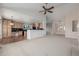 Open floor plan with living room blending into the kitchen with black countertops, hardwood floors and wood cabinets at 5204 Shetland Ct, Highlands Ranch, CO 80130