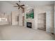 Living room with carpet, fireplace, shelving and a light-colored accent wall is next to the entryway and front door at 5204 Shetland Ct, Highlands Ranch, CO 80130