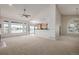 Bright living room with vaulted ceilings, carpet floors, fireplace and many windows to let the sunshine in at 5204 Shetland Ct, Highlands Ranch, CO 80130