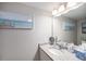 Bathroom featuring neutral walls, large mirror, granite counters and modern fixtures at 1646 S Deframe St # B8, Lakewood, CO 80228