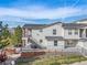 View of townhouses with balconies, stairs, brick accents, and green space at 1646 S Deframe St # B8, Lakewood, CO 80228