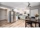 Bright kitchen with white cabinets, stainless steel appliances, and modern light fixture over the dining table at 1646 S Deframe St # B8, Lakewood, CO 80228
