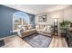 Cozy living room featuring a large window, comfortable sofa, and stylish decor at 1646 S Deframe St # B8, Lakewood, CO 80228