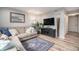 Living room with a comfortable sectional sofa, entertainment center, and modern decor at 1646 S Deframe St # B8, Lakewood, CO 80228