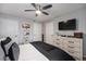 Aesthetic main bedroom featuring a ceiling fan, dresser, and wall-mounted TV with good closet space at 1646 S Deframe St # B8, Lakewood, CO 80228