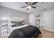 Comfortable main bedroom with a tufted headboard, ceiling fan, and stylish decor and ample closet space at 1646 S Deframe St # B8, Lakewood, CO 80228