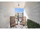 Patio featuring two chairs and a small table, with views of the complex at 1646 S Deframe St # B8, Lakewood, CO 80228