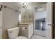 Well-lit bathroom featuring a white toilet, vanity, sink and an open doorway at 3969 S Fundy Cir, Aurora, CO 80013
