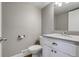 Well-lit half-bathroom featuring a toilet, sleek vanity with sink, and modern fixtures for convenience at 3969 S Fundy Cir, Aurora, CO 80013