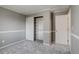 Neutral bedroom with wall to wall carpeting featuring sliding closet doors with open shelving at 3969 S Fundy Cir, Aurora, CO 80013