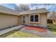 Home entrance featuring tidy landscaping, a security door, and adjacent window at 3969 S Fundy Cir, Aurora, CO 80013