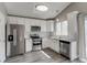 Updated kitchen with white cabinets, stainless steel appliances, and gray countertops at 3969 S Fundy Cir, Aurora, CO 80013