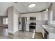 Updated kitchen featuring stainless steel appliances, and gray wood flooring at 3969 S Fundy Cir, Aurora, CO 80013
