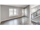 Living room featuring updated floors, a large front window, and an entrance to the kitchen at 3969 S Fundy Cir, Aurora, CO 80013