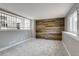 Open concept living room featuring carpeted floors and a feature wall made of wood planks at 3969 S Fundy Cir, Aurora, CO 80013